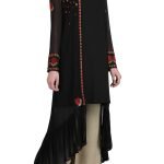 Black cape with slip and beige trousers