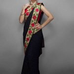 Black chiffon sari with antique gold zari embroidered border with red & fuchsia flowers