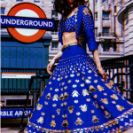 A blue mid calf length skirt embellished with gold sequins and acrylic mirrors